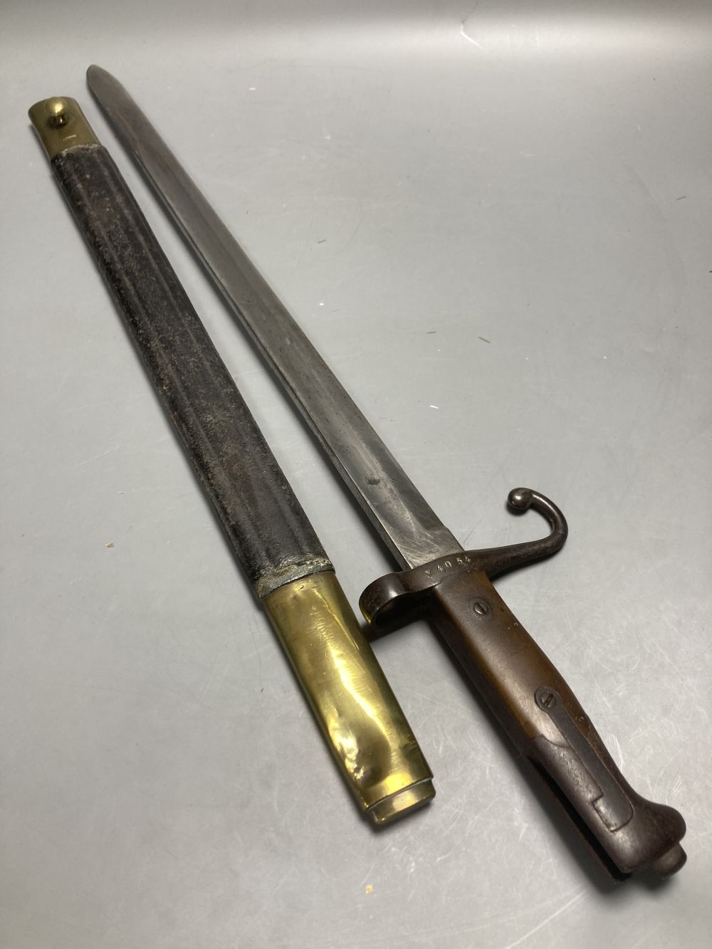 An Italian Torre Annunziata bayonet, 51cm blade, within leather and brass scabbard